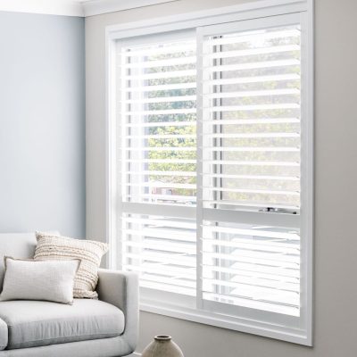Modern living room with 2 panel white plantation window shutters installed by Australian Plantation Shutters