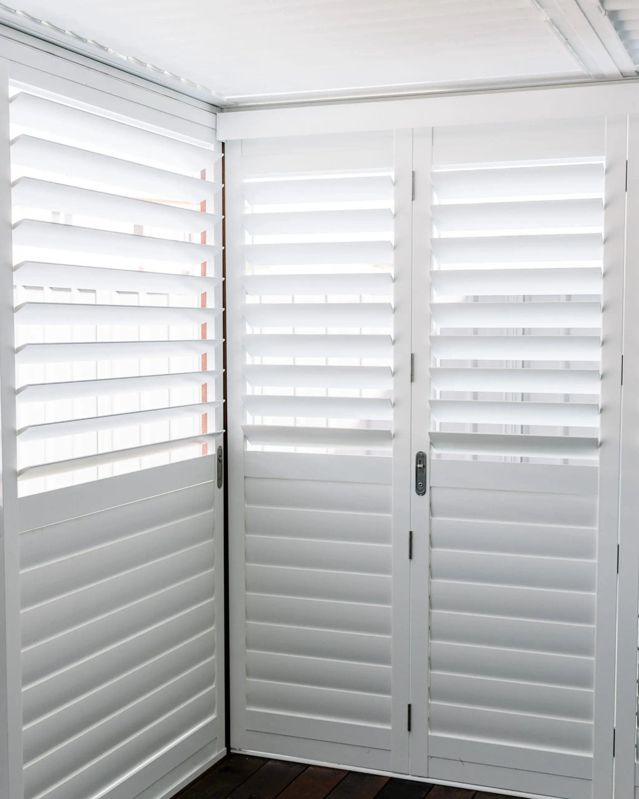 locked bifold white shutter doors by Australian Plantation Shutters