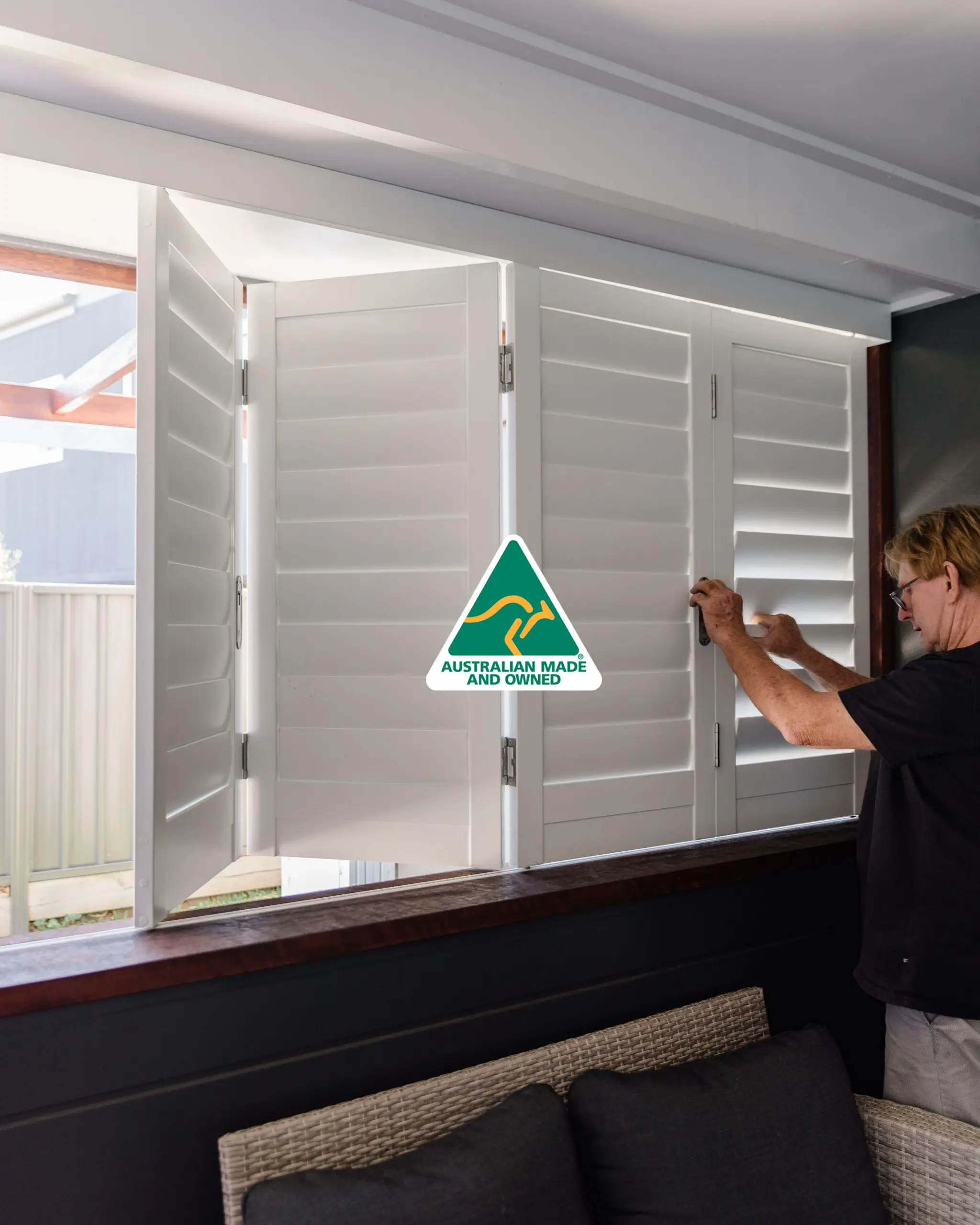 Australian Plantation Shutters technician installing Australian Made white plantation shutters.
