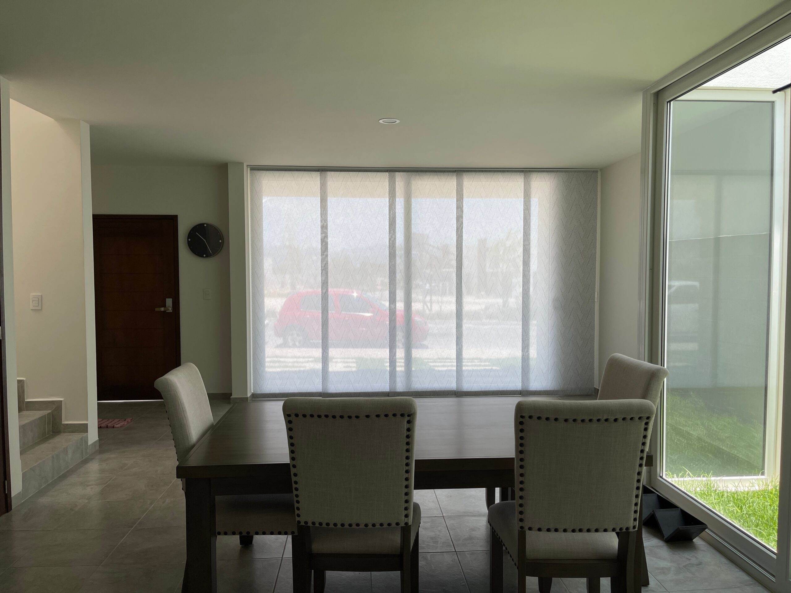 Light panel glide blinds designed by Australian Plantation Shutters installed in a modern dining room.