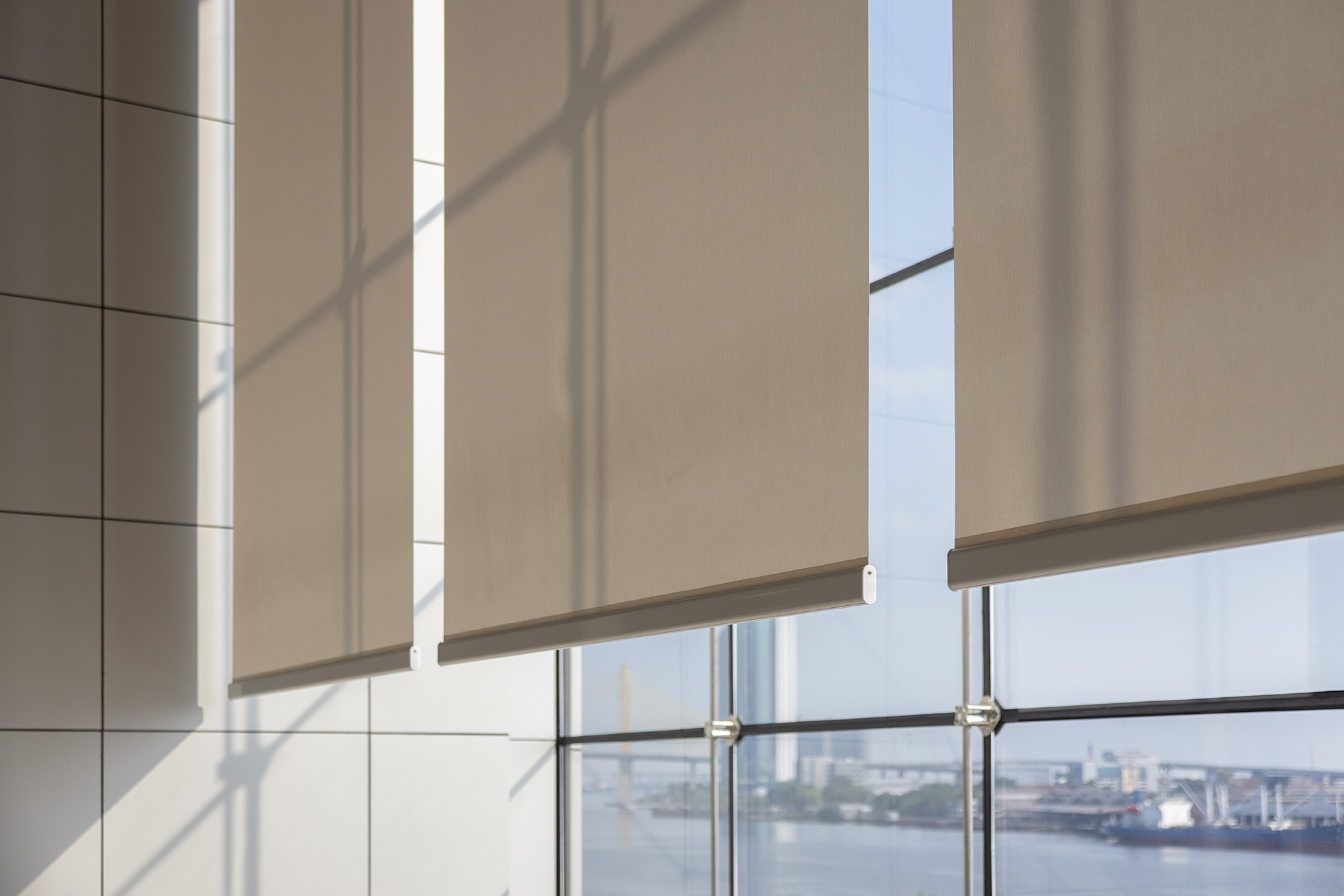 Beige Roller Blinds with City View installed by Australian Plantation Shutters