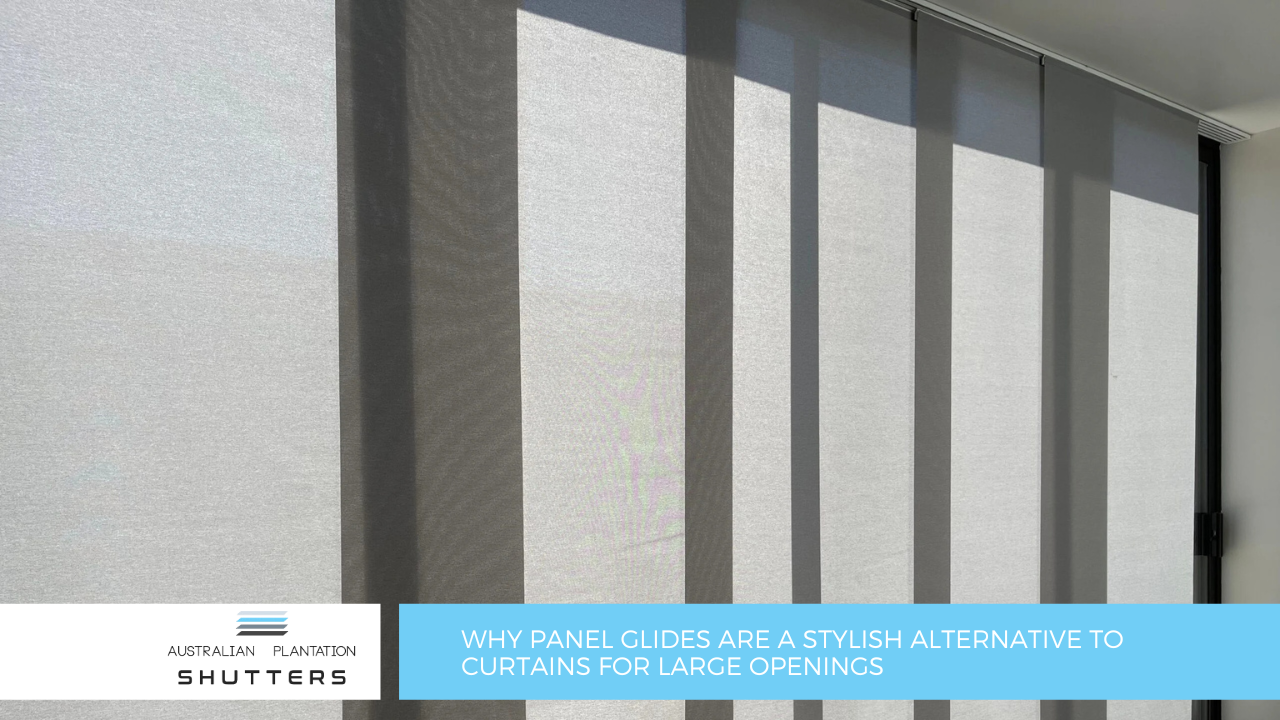 Light grey panel glide blinds covering a large window installed by Australian Plantation Shutters